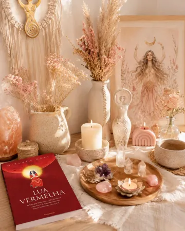 Altar com o livro Lua Vermelha, estatuetas da deusa, velas e cristais